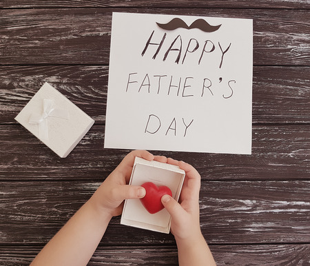 father's day, baby's hands, red heart on a black backgroundの写真素材