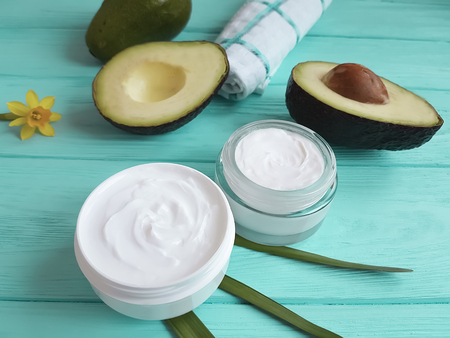 cream cosmetic, avocado on a wooden background, flowerの写真素材