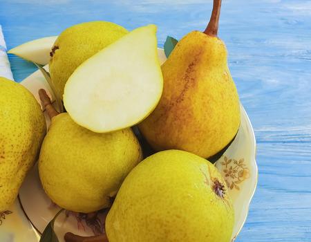 ripe organic pear on a wooden background autumn