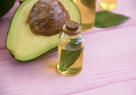 fresh avocado oil on a pink wooden