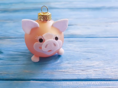 Christmas toy pig on a wooden backgroundの写真素材