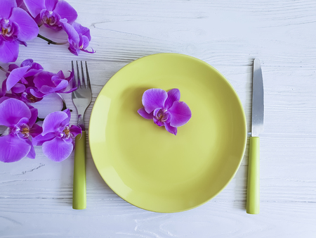 orchid flower plate on wooden backgroundの写真素材