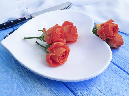 heart plate, rose flower on wooden backgroundの写真素材