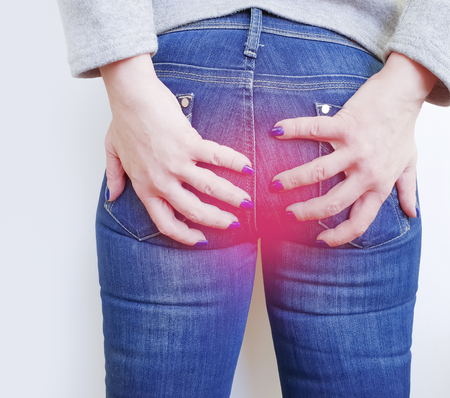 girl in jeans suffers from hemorrhoids, conceptの写真素材
