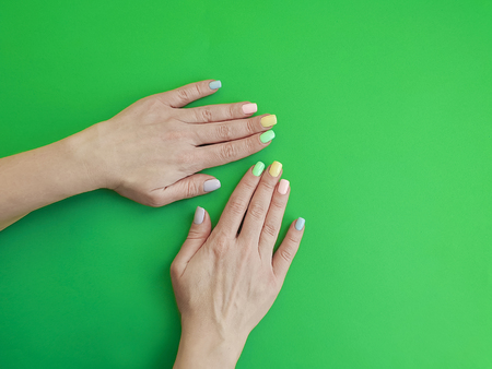 female hands manicure on color paperの写真素材