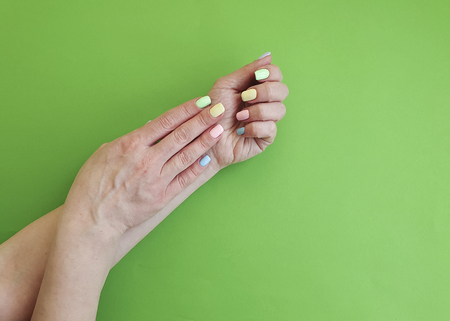 female hands manicure on color paperの写真素材