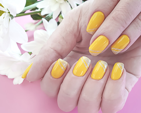 female hands manicure, chrysanthemum flowerの写真素材