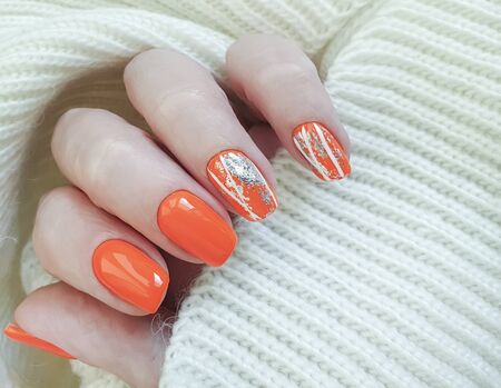 female hand beautiful manicure sweater