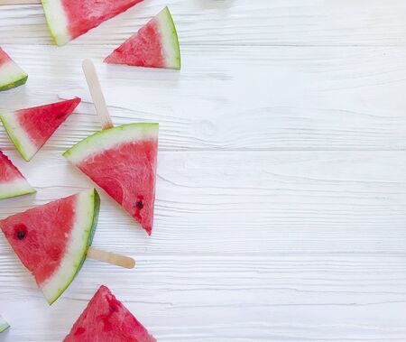 fresh watermelon slices on a wooden background