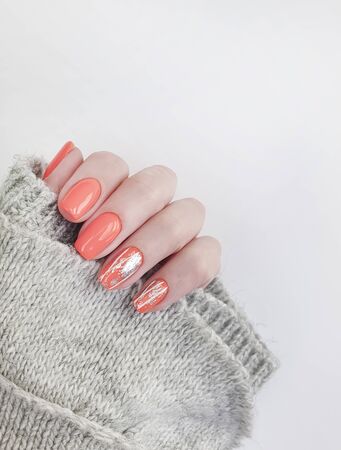 female hand beautiful orange manicureの写真素材