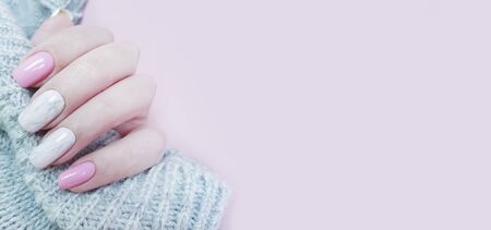 female hand beautiful stylish manicure sweater designの写真素材
