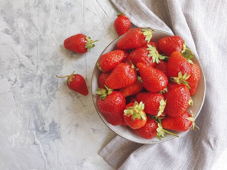 fresh strawberries in a plate on a concreteの写真素材