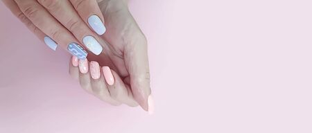 female hand beautiful manicure on a coloredの写真素材