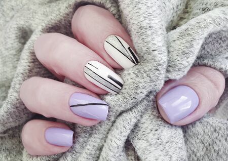 female hand nails beautiful manicure sweaterの写真素材