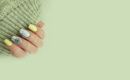 female hand beautiful manicure stylish sweaterの写真素材