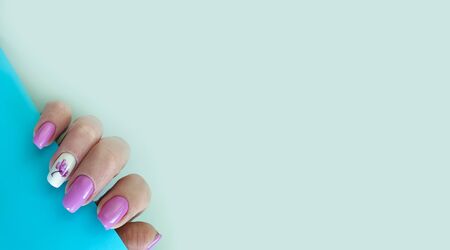 female hand nail beautiful manicure on a coloredの写真素材