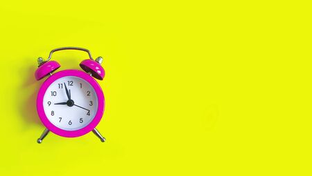 alarm clock on a colored background minimalの写真素材