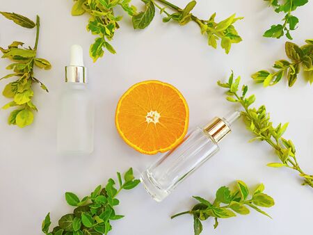 cosmetic cream, leaf, orange on a gray backgroundの写真素材