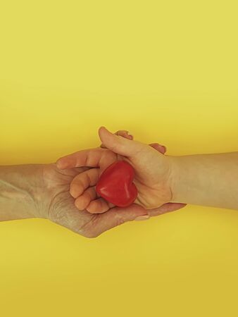 woman hand holds a child hand, heart