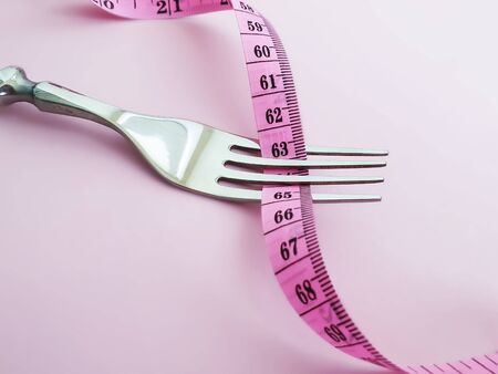 plug, measuring tape on a colored background, anorectionの写真素材