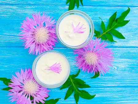 cream cosmetic flower on wooden backgroundの写真素材