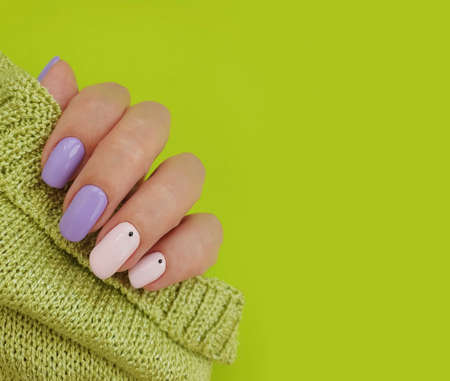 female hand beautiful manicure stylish sweater