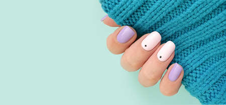 female hand beautiful stylish manicure sweaterの写真素材