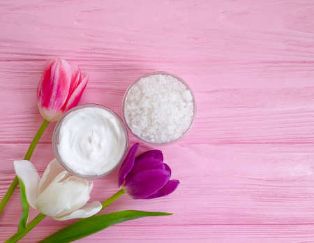 cream cosmetic flower tulip on wooden background