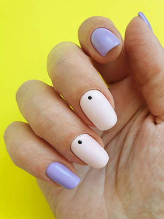 female hand beautiful stylish manicure on a colored background