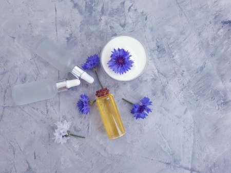 cream cosmetic flower cornflower on concrete backgroundの写真素材