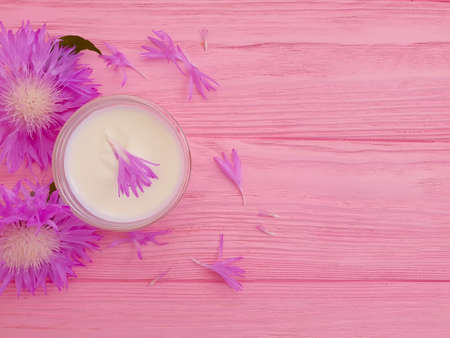 cream cosmetic flower on wooden backgroundの写真素材
