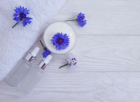 cream cosmetic flower cornflower on wooden backgroundの写真素材