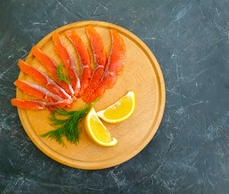 red fish salted pieces, lemon on concrete backgroundの写真素材