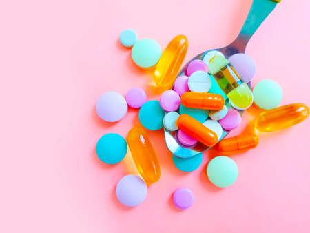 colored pills vitamins spoon backgroundの写真素材