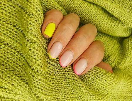 female hand beautiful manicure sweater