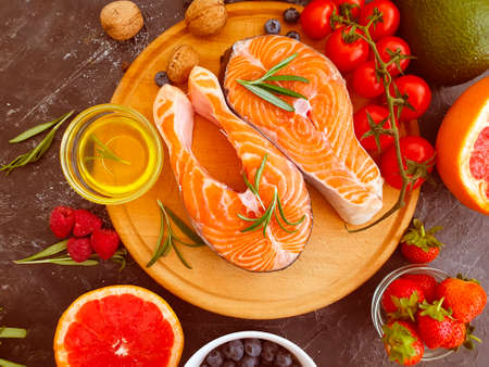 red fish steak, tomato on a concrete background
