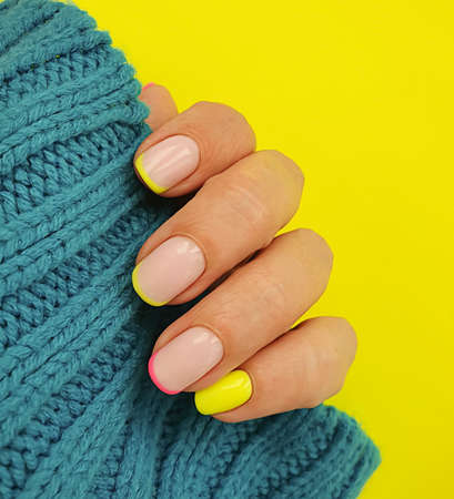 female hand beautiful stylish manicure sweaterの写真素材