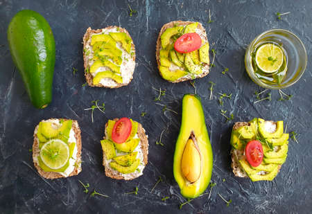 avocado sandwich on concrete background, tomato