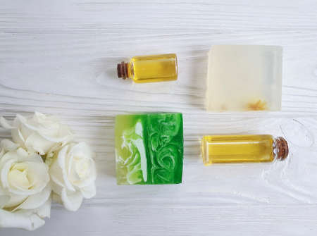 cosmetic oil rose flower on wooden background