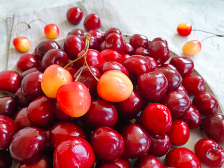 ripe cherries in a plate on concrete backgroundの写真素材
