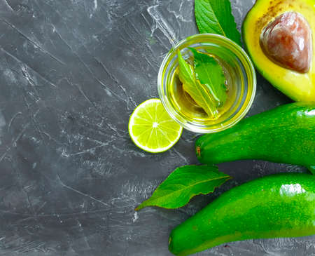 fresh avocado, lime concrete background