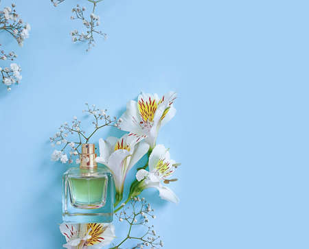 bottle perfume flower on a colored background