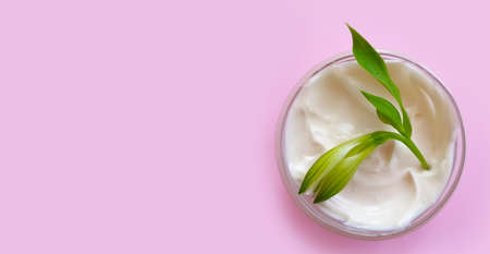 cosmetic cream, flower on a colored backgroundの写真素材