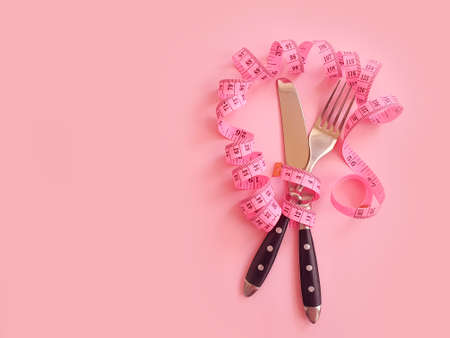 fork knife measuring tape on colored backgroundの写真素材