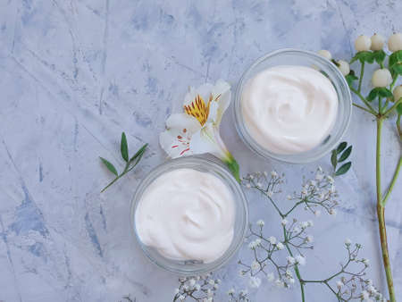 cosmetic cream, flower on on a concrete backgroundの写真素材