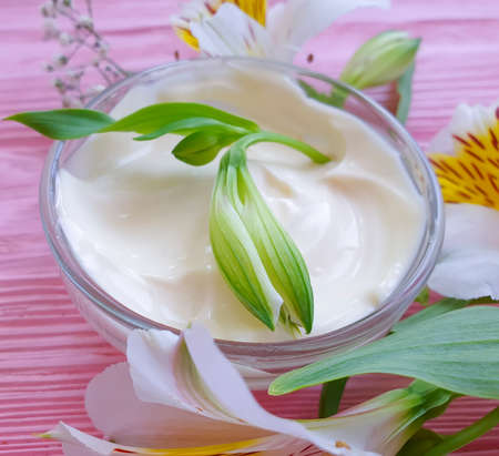cosmetic cream, flower on a wooden backgroundの写真素材