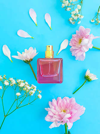 bottle perfume flower on a colored background