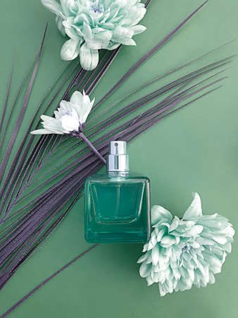 bottle perfume flower on a colored background