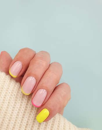 female hand beautiful manicure on a colored background