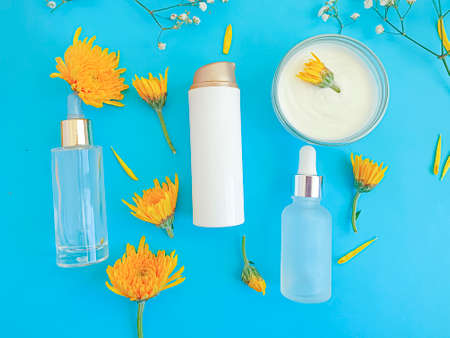 cosmetic cream, flower on a colored background